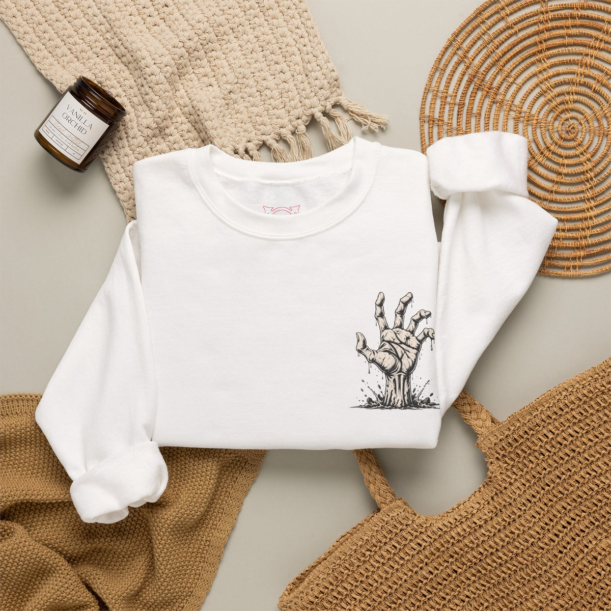 Still Reaching Zombie Hand Sweatshirt in White — folded view