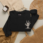 Still Reaching Zombie Hand Sweatshirt in Black — folded view